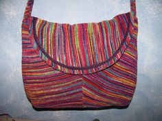 a multicolored purse hanging on the wall