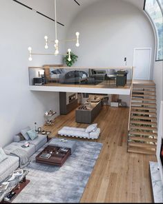 a living room filled with furniture and a stair case in the middle of the room