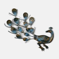 a metal sculpture of a bird with many feathers