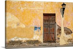 an old building with peeling paint and a wooden door