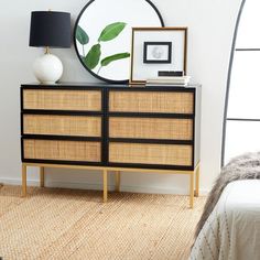 a bedroom scene with focus on the dresser and mirror, which is decorated with plants