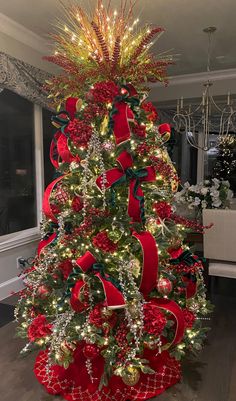 a decorated christmas tree with red bows and lights