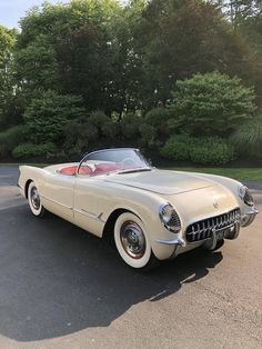 an old car is parked in the parking lot