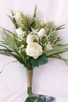 a bouquet of white flowers sitting on top of a table