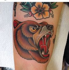 a bear with its mouth open and tongue out on the right side of his leg