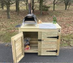 an outdoor bbq grill made out of wood