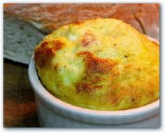 a close up of a bowl of food with bread in the background