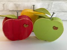 two apples are sitting next to each other in front of a brick wall with the word love written on it