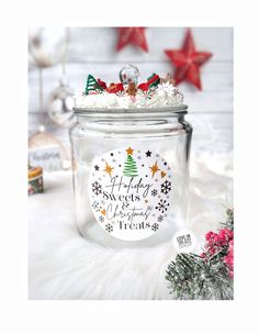 a glass jar filled with snow and christmas decorations