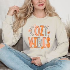 Looking for a cute versatile top to wear this summer? Make sure to grab one of our Cursive Fall Leaf Sweatshirts! This soft and comfortable shirt is the perfect top for any outfit. It can be paired with biker shorts, Jeans, or the classic stay at home sweats! The bright color adds a pop of summer to any outfit. This sweatshirt is true-to-size, so be sure to order your regular size! If you are looking for a more oversized look, make sure to size up. Comfy Cotton Tops With Cozy Fit, Cozy Cotton Tops For Lounging, Comfy Tops For Spring Lounging, Cute Cotton Tops For Lounging, Comfy Tops For Lounging In Spring, Trendy Tops For Lounging In Fall, Cozy Cotton Lounge Top, Comfortable Cozy Fit Tops For Lounging, Cozy Soft-washed Tops With Relaxed Fit