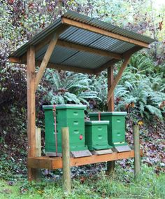 two beehives sitting on top of a wooden platform