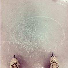 a pair of shoes sitting on top of a white floor next to a drawing in the snow