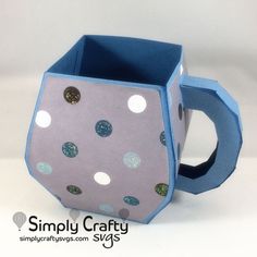 a cup that is made out of paper and has polka dots on the inside of it