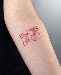 a woman's arm with a tattoo on it that says love is in the middle