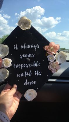 someone holding up a sign that says it always seems impossible until its done