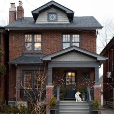 a large brick house with stairs leading to the front door