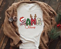 🎄 Celebrate the season with our charming Nana Claus Shirt, the perfect addition to your holiday wardrobe! This Vintage Nana Claus Shirt combines festive spirit and cozy comfort, making it the ideal Grandma Christmas Shirt for spreading joy at family gatherings. Give your holiday outfit a delightful twist with this must-have Christmas Nana Shirt! 🎅 Unwrap the enchantment of the holidays with our delightful Nana Claus Shirt! Crafted with love and nostalgia, this charming vintage piece captures t Christmas Shirts To Make, Nana’s Country Christmas, Nana Claus Svg, Nanas Shirt, Nana Christmas Shirt, Nana Sweatshirt, Grandpa Christmas, Grandmas Christmas, Nana Shirts