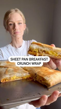 a woman holding a tray with some food on it and the words sheet pan breakfast crunch wrap