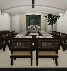 a dining room table set with place settings for eight people and a potted plant in the center