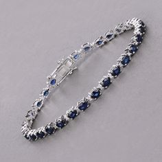 Genuine Blue Sapphire Ovals and Diamond White Gold Bracelet for Women, 14k Gold Sapphire Tennis Bracelet, September Birthstone Bracelet Adorn your wrist with this stunning 14K white gold tennis bracelet, featuring 5.80 carats of genuine oval blue sapphires and 0.23 carats of genuine round white diamonds. The rich blue sapphires, September's birthstone, are beautifully accented by the brilliance of white diamonds. Designed with a secure box clasp, this bracelet is perfect for special occasions or everyday luxury. Celebrate September birthdays or simply enjoy its timeless elegance with this exquisite piece. Product Details:  14K White Gold Item Type: Bracelet Gross Wt: 10.67 Gemstone Wt: 5.80 ctw Diamond Wt: 0.23 ctw Total Stone Wt: 6.03 ctw Finish: Fine Finish Product Style: Tennis Bracelet Blue Oval Diamond Bracelet With Jewels, Luxury Blue Oval Diamond Bracelet, Sapphire Gemstone Tennis Bracelet With Oval Shape, Sapphire Gemstone Tennis Bracelet In Fine Jewelry Style, Fine Jewelry Sapphire Gemstone Tennis Bracelet, Fine Jewelry Sapphire Tennis Bracelet, Sapphire Gemstone Tennis Bracelet, Oval Sapphire Gemstone Tennis Bracelet, Elegant Sapphire Round Tennis Bracelet