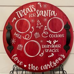 a red sign with white writing on it that says treats for santa and cookies, reindeer snacks, save the christmas tree