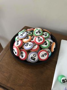 a bowl full of pool balls on top of a table