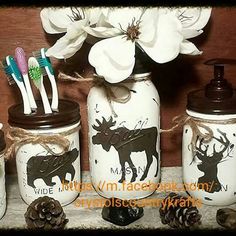 three mason jars with toothbrushes and toothpaste are sitting on a table