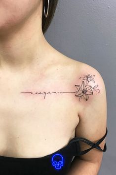 a woman with a tattoo on her chest that says, happiness and a flower in the center