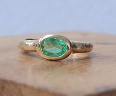 This vintage 14k yellow gold ring features a stunning natural Colombia emerald with an oval cut, bezel set for security. The beautiful green color of the main stone represents nature and makes it perfect for occasions such as engagement, anniversary, birthday, Mother's Day, or Christmas. The ring has a unique cocktail style and a ring size of 5.5, which can be resized if needed. Gorgeous vintage 14k yellow gold natural green Colombian emerald in oval shape circ 1940s Center natural green Colombi Oval Emerald Ring With Bezel Setting, Gold Oval Emerald Ring, Oval Emerald Ring In Gold, Heirloom Oval Green Emerald Ring, Gold Oval Emerald Ring With Bezel Setting, Green Emerald Ring With Oval Cabochon Bezel Setting, Gold Emerald Ring With Bezel Setting In Oval Shape, Vintage Oval Emerald Ring In 14k Gold, Handmade Oval Emerald Ring In 14k Gold