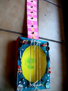 a guitar made out of paper and string