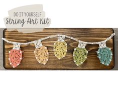 string art kits are hanging on a wooden board