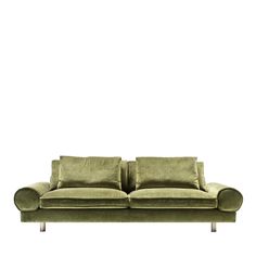 a green couch sitting on top of a white floor