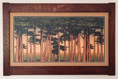 a painting hanging on the wall in front of a wooden frame with trees painted on it