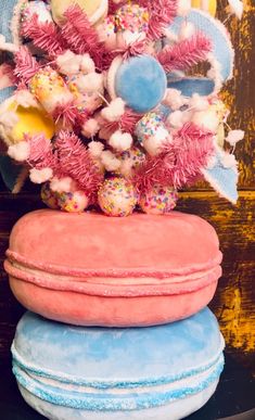 three round cushions stacked on top of each other in front of a wooden wall and decorated tree