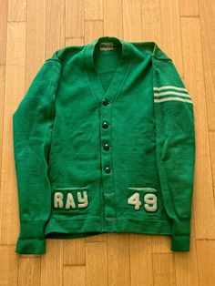 1940s Green Varsity Cardigan Dehen Knitting Co tag size S/M Measurements: shoulders 19  p2p 20 length 26 sleeve from HPS 27 Dillon normally wears a size L top and size 32 bottom. Thanks for checking out my listings, follow @QuotidianRagazine on Instagram for more! Items from the shop are in a vintage condition, and any blemishes, distressing, fading, missing buttons, or other flaws are shown as clearly as possible in photographs. The aim of this project is to give continued life to vintage styles that have been well worn and well loved. Please assess condition and reach out with any concerns before purchasing - all purchases are final sale. Vintage Green Long Sleeve Cardigan, Retro Cotton Cardigan With Button Closure, Vintage Sweater For Workwear, Vintage Long Sleeve Sweater For Work, Green Vintage Cardigan, Vintage Winter Workwear Cardigan, Vintage Long Sleeve Cardigan With Button Closure, Vintage Fall Sweater For Work, Vintage Green Cardigan For Fall