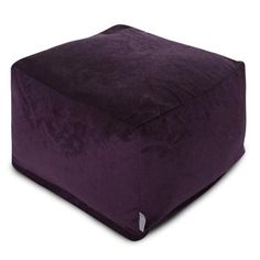 a purple square ottoman sitting on top of a white floor