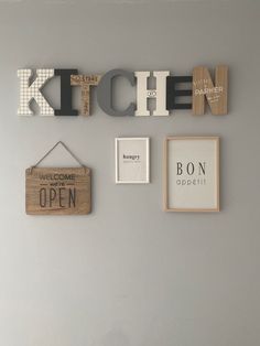 the kitchen is decorated with wooden letters and magnets to spell out things that are open