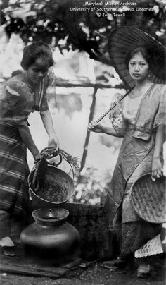 two women standing next to each other holding baskets