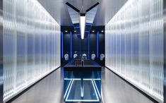 a very long narrow bathroom with blue lighting