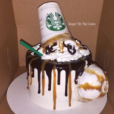 a starbucks cake in a box with ice cream and caramel drizzle on top