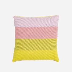 a pink and yellow pillow on a white background