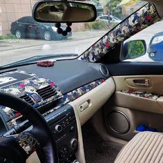 the interior of a car with an elaborately decorated dash board and steering wheel cover