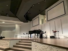 an empty stage with a piano and other musical instruments