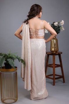 Beige pre-draped sequin lycra saree. Comes with a hand tasseled, padded blouse made with Swarovski and glass beads. - Aza Fashions Lycra Saree, Sequin Saree, Padded Blouse, Drape Saree, Swarovski Beads, Beaded Neckline, Blouse For Women, Saree With Blouse, Aza Fashion