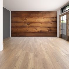 an empty room with wood paneling on the wall