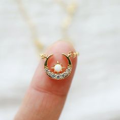 "Beautiful and lovely gold moon necklace made of tiny cubic and opal gold moon charm with skinny gold plated brass chain. The soft and warm-looking necklace is good for yourself or gift! Your necklace will ship in a rudiana gift box. ♥Length 14\" - 20\" ♥Moon charm 1/2\" x 1/2\" ♥Gold plated over brass / Cubic Zirocnia / Opal stone ♥ Delivery Time Fast shipping within 1 - 3 days ♥ See more Rudiana Accessories Rudiana.etsy.com" Opal Moon Necklace, Gold Crescent Moon, Prom Necklaces, Gold Moon Necklace, Celestial Necklace, Gold Cross Necklace, Gold Charm Necklace, Infinity Necklace, Pendent Necklace