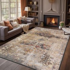 a living room filled with furniture and a large rug on top of a hard wood floor