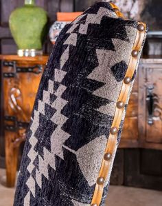 a black and white blanket sitting on top of a wooden table