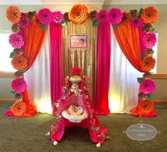 a decorated stage with pink and orange flowers