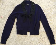 DKNY navy blue/black cardigan! Size small. Long sleeves. Beaded and sequined around the neck and on the front. Tie front. Great condition. Measurements laying flat/unstretched: bust: 16.5”, length from shoulder: 20” Blue Long Sleeve Cardigan For Formal Occasions, Blue Long Sleeve Formal Cardigan, Dainty Cardigan, Sleeve Cardigan, Long Sleeve Cardigan, Black Cardigan, Black Beads, Cardigan Sweater, Sweater Cardigan